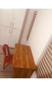 KondottiRedbell Inn Airport Hotel的木桌和红色椅子