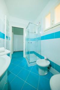 蒂勒尼亚Residence San Francesco的蓝色的浴室设有2个水槽和淋浴。