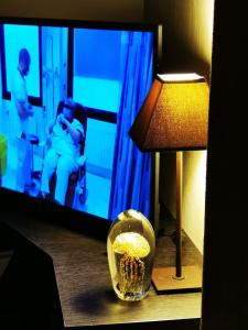 文代讷escale océane的一间设有一盏灯、一台电视和一碗爆米花的房间