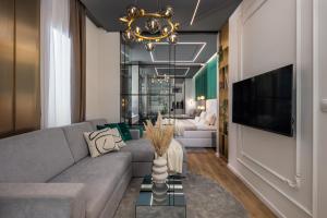 里耶卡Dream Fiumara Apartments的客厅配有灰色的沙发和吊灯。