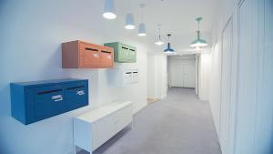 瓦讷LE LAC au DUC的厨房的墙壁上设有蓝色和绿色的橱柜。