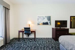 舒格兰Best Western Sugar Land - Richmond的酒店客房配有书桌、床和电视。