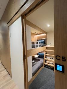 多哈sleep 'n fly Sleep Lounge & Showers, NORTH Node - TRANSIT ONLY的一间小房间,房间内设有一张双层床