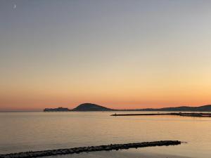 福尔米亚Sogno Mediterraneo的日落在水体上,有码头