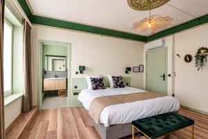 WatervlietBoutique hotel Sies的一间卧室设有一张大床和绿色的墙壁