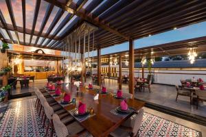 吉达Narcissus Obhur Resort & Spa的餐厅设有一张大型木桌和椅子