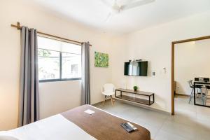 坎昆Viento Suites Cancún的一间卧室配有一张床、镜子和一张书桌