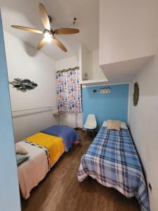 皮昂比诺La Palma appartamenti的一间卧室配有两张床和吊扇