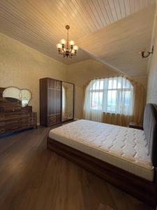 沙马基Shamakhi Villa的一间卧室配有一张大床和一个吊灯。