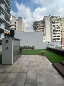 布宜诺斯艾利斯Apartment in Downtown Buenos Aires的后院设有白色的墙壁和草坪