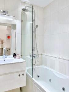 索非亚Vintage Top Centre Apartment的白色的浴室设有浴缸和水槽。