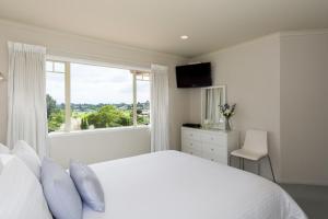 陶朗加海景别墅住宿加早餐酒店的白色的卧室设有一张大床和一个窗户