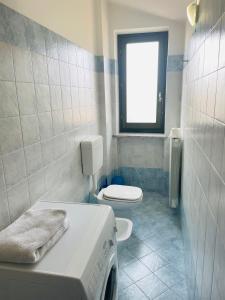 蒙福特达尔巴Soggiorno con splendida vista的浴室设有床、卫生间和窗户。