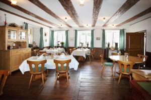 苏尔茨堡Landgasthof Rebstock的一间在房间内配有桌椅的餐厅