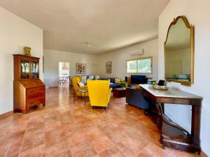 希克利Villa BeaBella的客厅配有桌子和黄色椅子