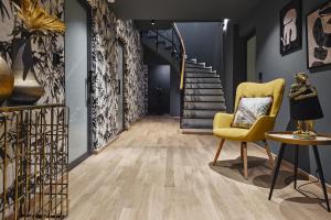 雅典Cama Luxury Suites的走廊设有黄色椅子和楼梯