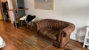 慕尼黑Apartment in München的客厅配有棕色沙发和玻璃桌