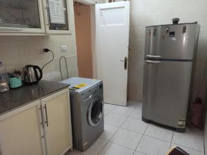 开罗Golden Star Hostel的厨房配有洗衣机和冰箱。