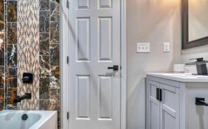 巴尔的摩On Ensor的浴室设有白色门和水槽