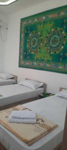 布哈拉KAMIR Guest House的一组床铺,上面有毛巾