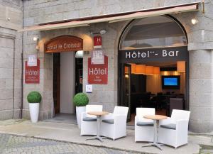圣马洛Hotel Le Croiseur Intra Muros的酒店酒吧前面设有白色的椅子和桌子