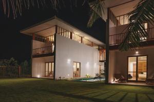 坦加拉Sati Villa Rekawa Beach Sri Lanka的一座晚上设有游泳池的房子