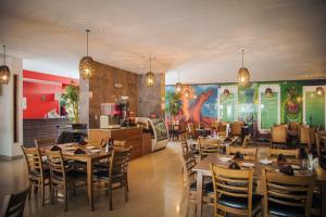 拉巴斯Hotel Maioris La Paz的一间带桌椅的餐厅和一间厨房
