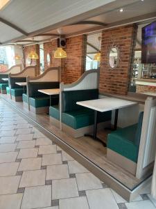 圣马洛Hotel De La Mer的用餐室配有桌子和绿色椅子