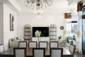 黄金海岸stunning prestige residence的一间带桌子和吊灯的用餐室