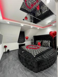 多特蒙德Phöenixpalace Whirlpool & Infarotsauna的一间卧室配有一张红心的黑色床