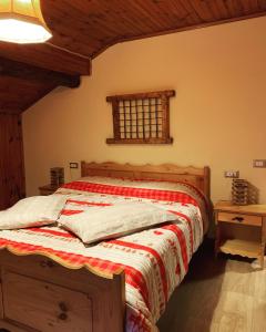 BordognaLa Mansarda di Casa Vacanze La Vite的一间卧室配有一张带红白毯子的床