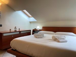 Bovísio-Masciago MilaneseAppartamento Bovisio Via Comasinella的卧室配有带毛巾的大型白色床