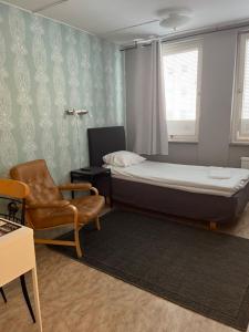 卡尔斯克鲁纳得罗宁家塔斯旅舍的一间小卧室,配有一张床和一把椅子