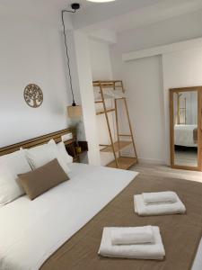 科尔多瓦APARTAMENTO MEDINA AZAHARA的一间卧室配有一张床,上面有两条毛巾