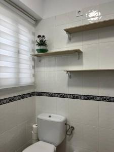 卢塞纳LA DESCALZA的白色的浴室设有卫生间和窗户。