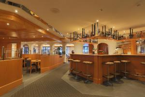 萨斯费阿尔宾高级酒店的餐厅设有带凳子的酒吧