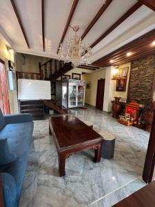 琅勃拉邦Chaluenxay Xiengthong Place的客厅配有木桌和吊灯。