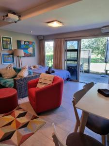 芒格努伊山The Sandy Golfer的客厅配有床和红色沙发