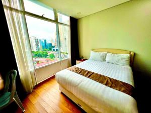 吉隆坡Vortex suites near by KLCC的一间卧室设有一张床和一个大窗户