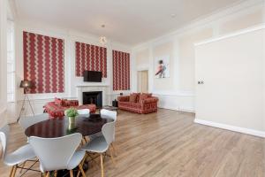 爱丁堡爱丁堡目的地约克广场公寓的客厅配有桌椅和壁炉