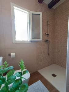 科托里奥斯El Fresno Cazorla的带淋浴和卫生间的浴室以及窗户。