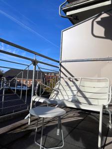 杜塞尔多夫AvidonApartments的阳台顶部的白色椅子
