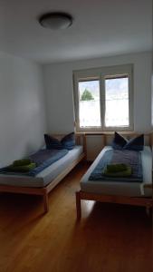 多恩比恩Dimai House No 31 Dornbirn Messe的带2扇窗户的客房内的2张床