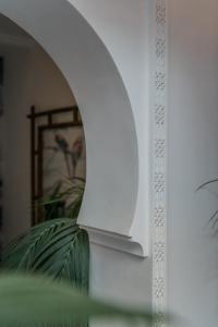 马拉喀什Riad Le Saadien的客房内的白色墙壁和拱门