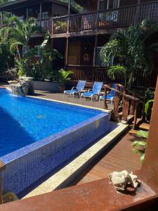 桑迪湾Blue Bahia Resort的一座游泳池旁设有两把躺椅