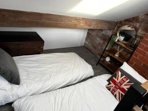 哈利法克斯Unique Victorian stable conversion Halifax的一间卧室配有两张床和镜子