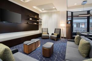伍斯特伍斯特万怡酒店的一间设有椅子和平面电视的等候室