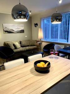 雷克雅未克Cosy one bedroom apartment in Reykjavík的客厅配有一张桌子,放着一碗水果和酒杯