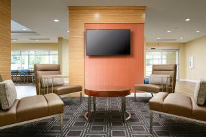 塔斯卡卢萨TownePlace Suites by Marriott Tuscaloosa的一间墙上配有平面电视的等候室