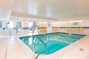 圣查尔斯万豪芝加哥圣查理斯费尔菲尔德客栈及套房的游泳池位于酒店客房内,配有黄色椅子